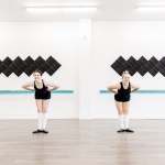 Two dancers smile and bow