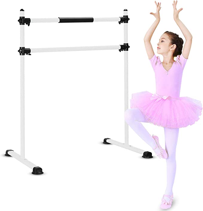 A ballerina in pink next to a free standing barre