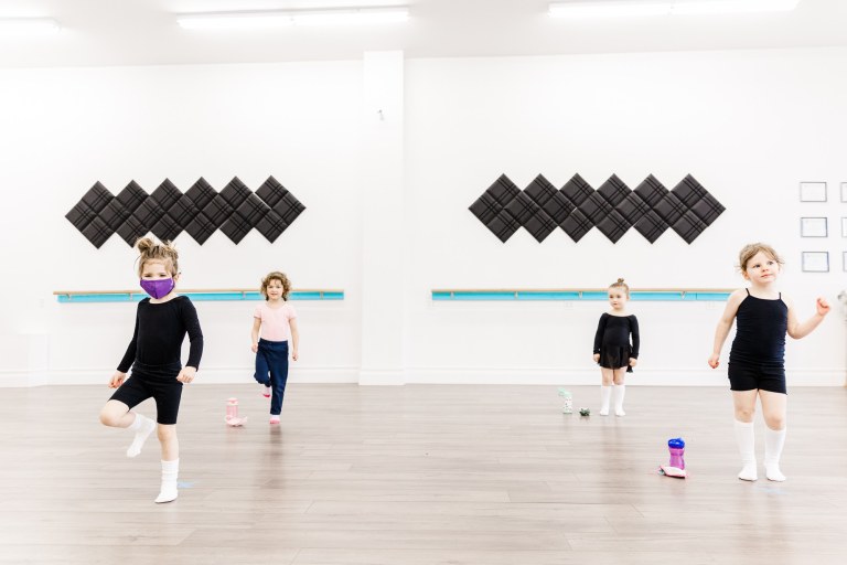 4 young dancers in a white room