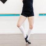 A dancer posing in a white room