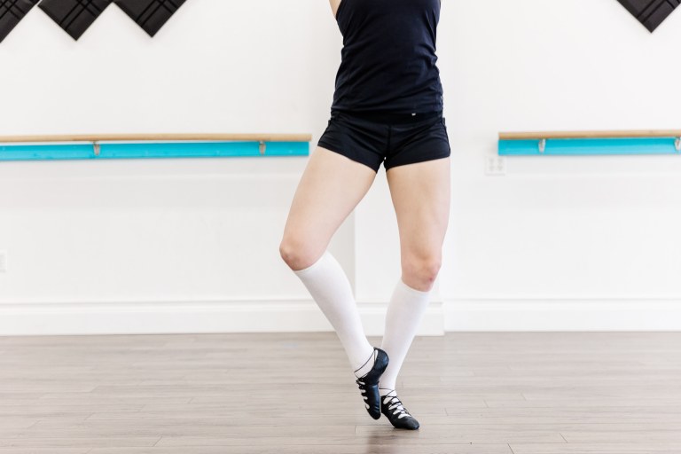 A dancer posing in a white room