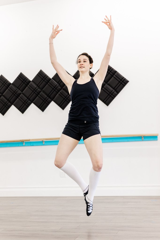 A dancer posing wearing black