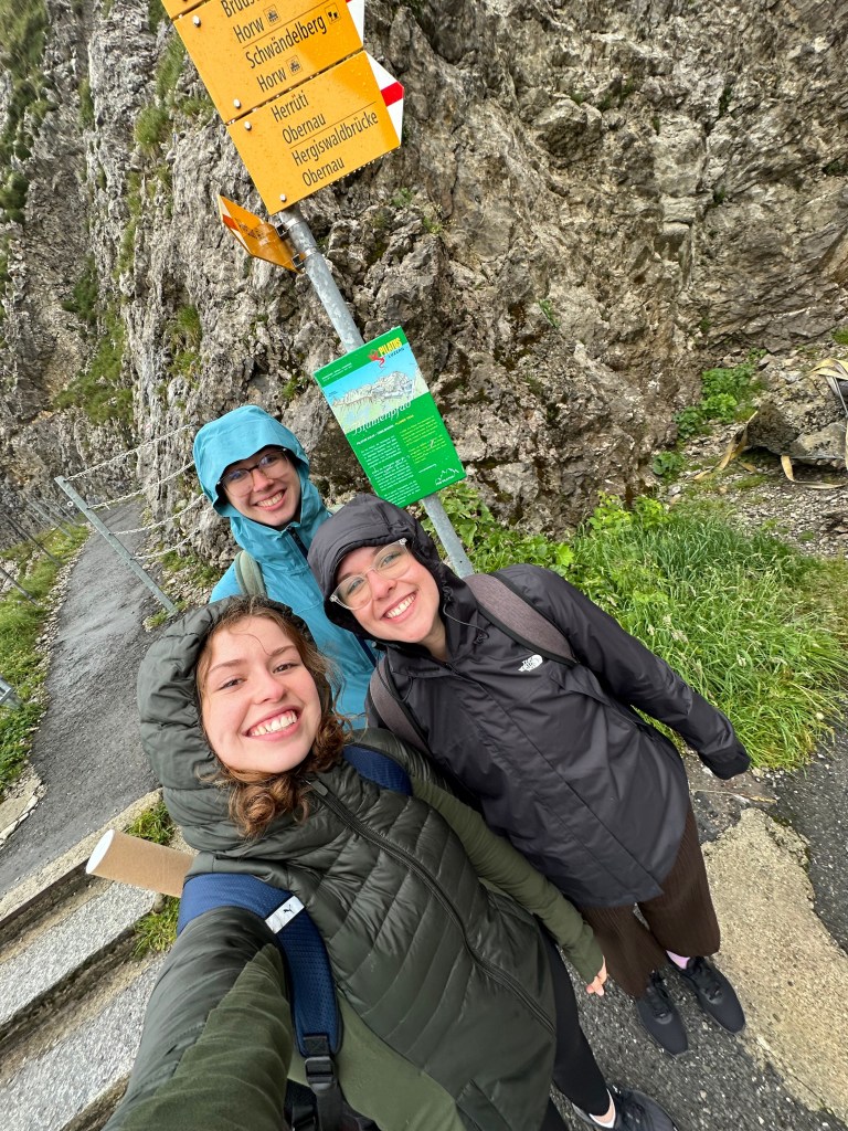 3 women take a selfie in rain jackets