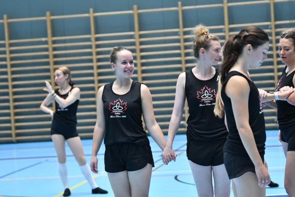 5 dancers in black outfits