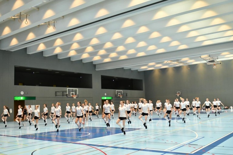 Dancers in formation in white t shirts