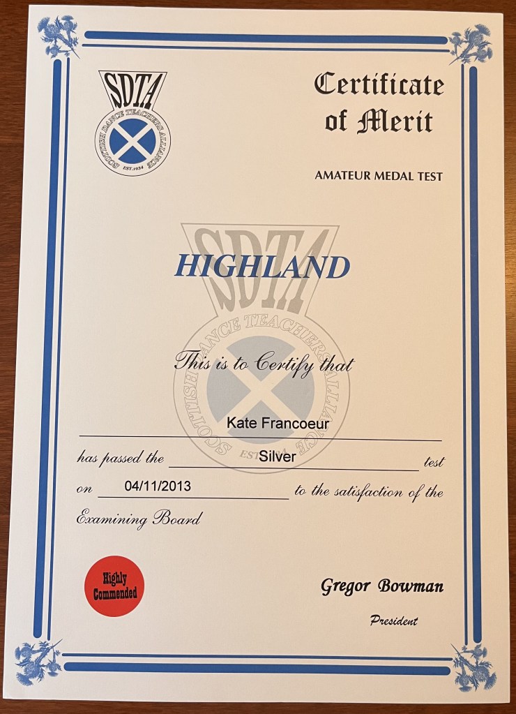 A white certificate paper that reads "Highland | this is to certify that Kate Francoeur has passed the Silver test"