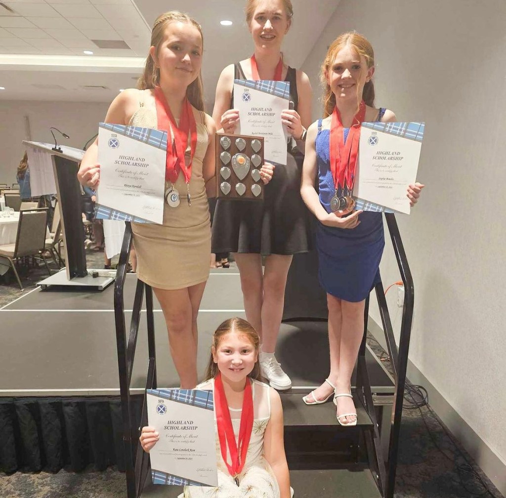 4 girls smile holding certificates
