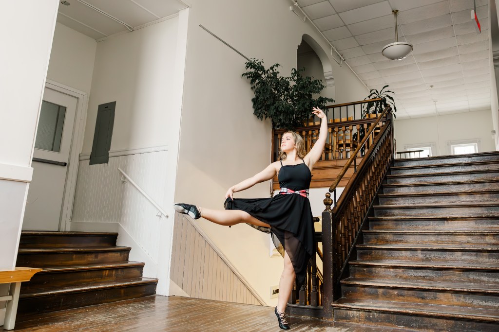 A dancer poses in a hallway