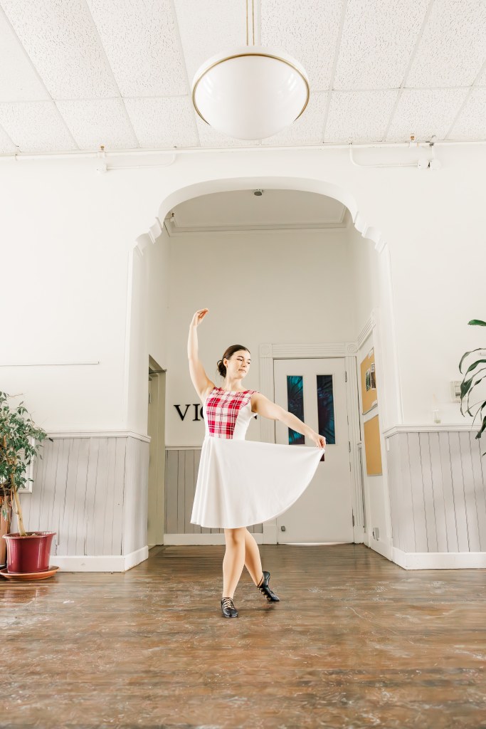 A dancer poses in a hallway