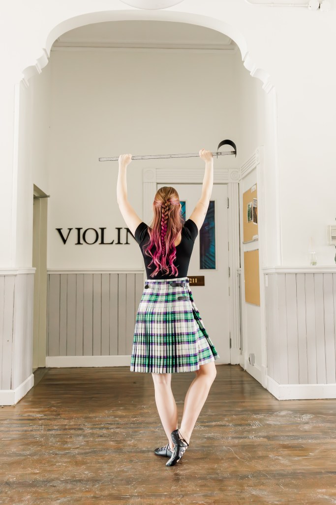 A dancer poses in a hallway