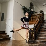 A dancer poses in a hallway