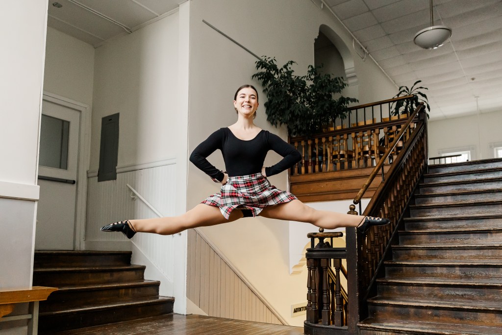 A dancer poses in a hallway