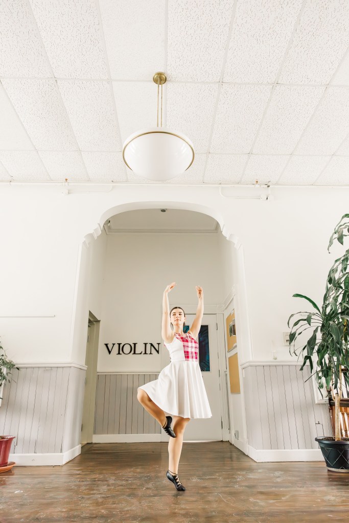 A dancer poses in a hallway