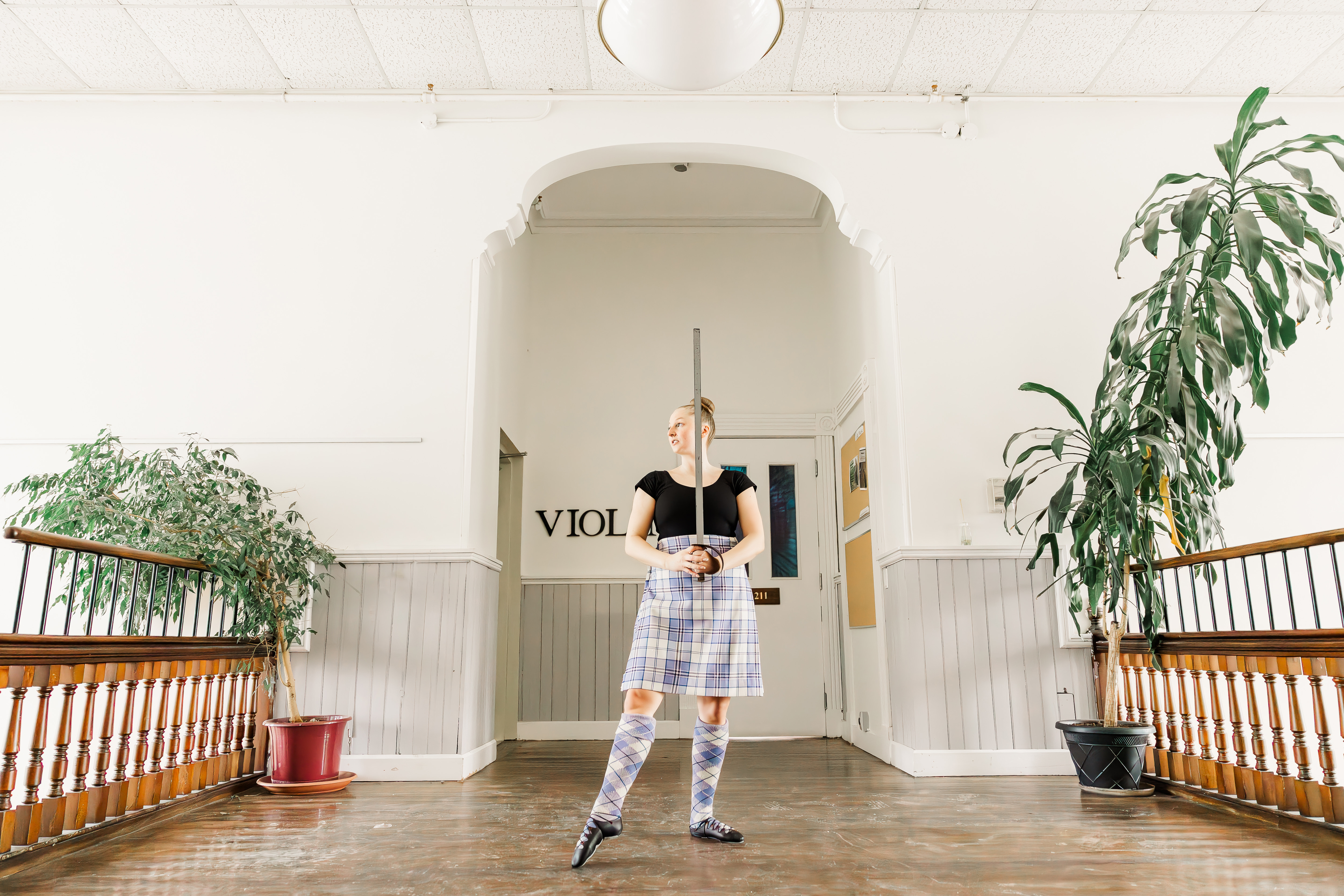 A dancer poses in a hallway
