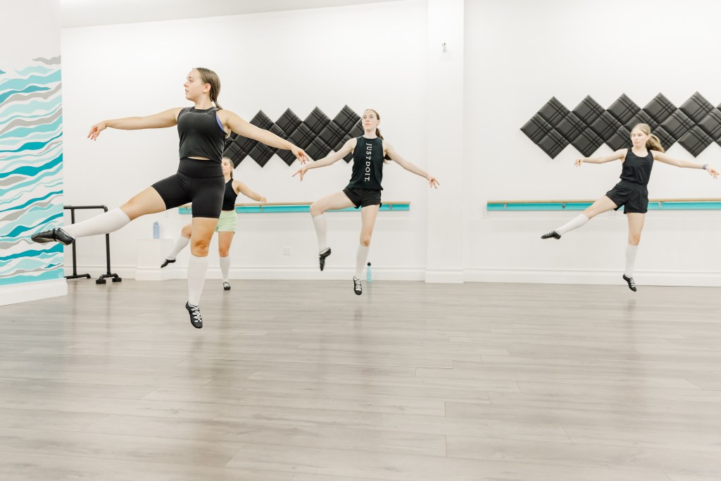 4 dancers hopping in a white room