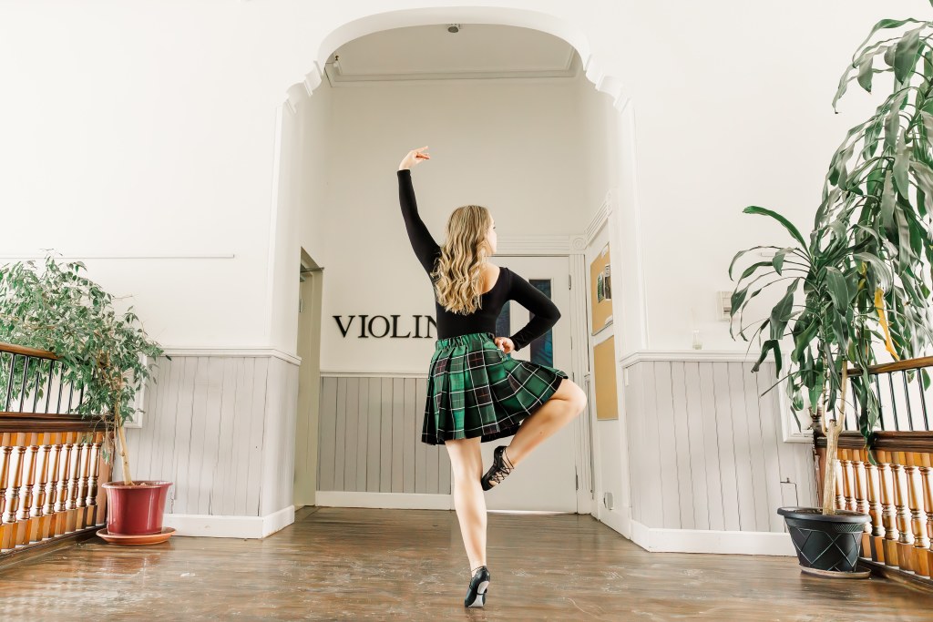 A dancer poses in a hallway