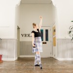 A dancer poses in a hallway
