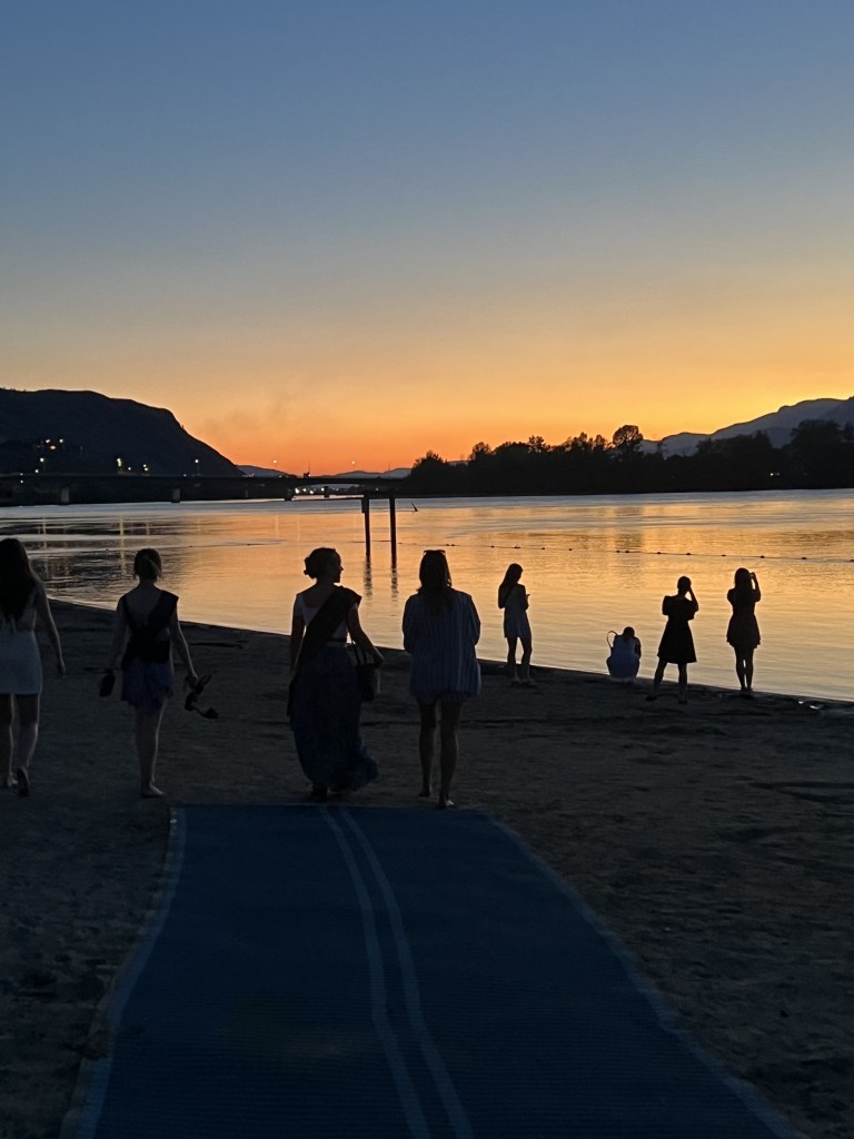 Silhouettes of people on a beach at sunset