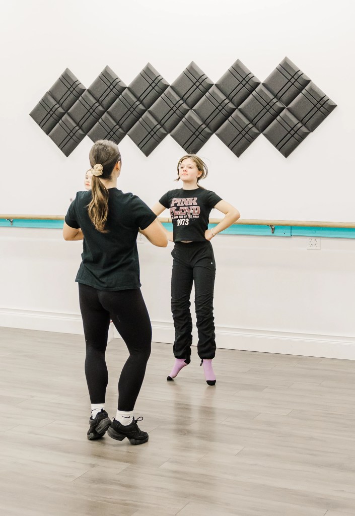 A highland dancer and dance instructor, both wearing black. Saorsa Studio offers Highland Dance classes for ages 1 to adult in Fredericton, New Brunswick.